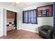 Bedroom with ceiling fan, wood-look tile floor, closet with organizers, and Tom Brady memorabilia at 4003 W Lemon St, Tampa, FL 33609