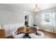 Bright dining area featuring a round table with a view to the front yard through sheer curtains to allow natural light at 4003 W Lemon St, Tampa, FL 33609