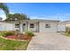 Charming single-story home featuring a well-manicured front yard and a paver driveway and a pleasing front entrance at 4003 W Lemon St, Tampa, FL 33609