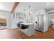 Modern kitchen features white cabinets, stainless steel appliances, and a stylish island with seating at 4003 W Lemon St, Tampa, FL 33609
