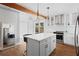 This well-appointed kitchen features a breakfast bar island, stainless appliances, wood floors, and a sliding door to the patio at 4003 W Lemon St, Tampa, FL 33609