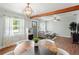 Stylish living area features an adjacent dining room, wood flooring, modern lighting, and a view of the outdoors at 4003 W Lemon St, Tampa, FL 33609