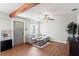 The living room features wood flooring, a comfortable gray sofa, decorative ceiling fan, and natural light at 4003 W Lemon St, Tampa, FL 33609