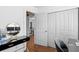 Bright office space featuring a glossy black desk, stylish mirror, and closet for ample storage at 4003 W Lemon St, Tampa, FL 33609