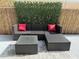 Comfortable outdoor seating area with a wicker sofa, glass table, bright pillows and decorative foliage, perfect for relaxation at 4003 W Lemon St, Tampa, FL 33609