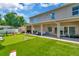 Expansive backyard with artificial grass, covered patio, and outdoor seating area at 4612 Netherwood Dr, Tampa, FL 33624