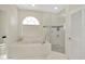 This well-lit bathroom features a glass shower, large tub, and a window for natural light at 4612 Netherwood Dr, Tampa, FL 33624