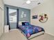 Bedroom featuring bright window, game controller decor, and grey bed frame at 4612 Netherwood Dr, Tampa, FL 33624