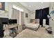 Neutral bedroom with modern desk, light wood flooring, and black-out curtains at 4612 Netherwood Dr, Tampa, FL 33624