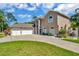 Lovely two-story home with three-car garage, blue door and well-maintained lawn at 4612 Netherwood Dr, Tampa, FL 33624
