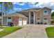 Stunning two-story home with an attached three-car garage, blue door, and manicured front yard at 4612 Netherwood Dr, Tampa, FL 33624