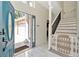 Bright foyer with marble floors, stairway, and an open view to the front door and garage at 4612 Netherwood Dr, Tampa, FL 33624