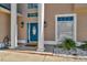 Close up on the elegant blue front door framed by stately columns and stone landscaping at 4612 Netherwood Dr, Tampa, FL 33624