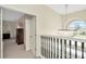 Upstairs landing view showcasing a hanging light fixture and open doorway to the bedroom at 4612 Netherwood Dr, Tampa, FL 33624