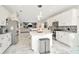 Open-concept kitchen features stainless appliances, granite countertops, and a large island at 4612 Netherwood Dr, Tampa, FL 33624