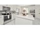 Bright kitchen features white cabinets, stainless appliances, stylish backsplash, and large island at 4612 Netherwood Dr, Tampa, FL 33624