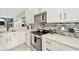 Updated kitchen features sleek appliances, mosaic backsplash, and white countertops at 4612 Netherwood Dr, Tampa, FL 33624