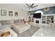 Open-concept living room features a cozy sectional sofa and a fireplace at 4612 Netherwood Dr, Tampa, FL 33624