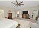 Spacious main bedroom features a ceiling fan, dressers, TV, and a walk-in closet entrance at 4612 Netherwood Dr, Tampa, FL 33624