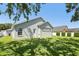 Well-maintained backyard with lush green lawn and white back door access to the home's interior at 5119 Whispering Leaf Trail, Valrico, FL 33596