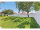 Spacious backyard featuring a lush lawn, mature trees, and a privacy fence at 5119 Whispering Leaf Trail, Valrico, FL 33596