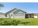 The backyard shows a grassy area with a screened in porch attached to the back of the home at 5119 Whispering Leaf Trail, Valrico, FL 33596
