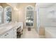 Spacious bathroom with double sinks, a walk-in shower, and a soaking tub at 5119 Whispering Leaf Trail, Valrico, FL 33596