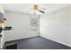 Minimal bedroom with a window, ceiling fan, and mounted TV, offering a cozy, clutter-free living space at 5119 Whispering Leaf Trail, Valrico, FL 33596