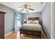Serene bedroom with wood floors, queen bed, and soft, inviting natural light at 5119 Whispering Leaf Trail, Valrico, FL 33596