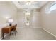 Spacious beige bedroom with tray ceiling, desk and ample natural light perfect for relaxation and productivity at 5119 Whispering Leaf Trail, Valrico, FL 33596