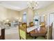This elegant dining area boasts beautiful natural light and neutral decor that extends into the living room at 5119 Whispering Leaf Trail, Valrico, FL 33596