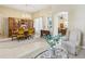 Dining room showcasing elegant seating, chandelier lighting, and seamless flow into the living area at 5119 Whispering Leaf Trail, Valrico, FL 33596