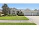 Charming single-story home with a well-manicured lawn and a three-car garage at 5119 Whispering Leaf Trail, Valrico, FL 33596