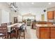 Open kitchen and dining area with stainless steel appliances, tile floors and backsplash, and natural light at 5119 Whispering Leaf Trail, Valrico, FL 33596