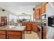 Bright eat-in kitchen with stone countertops, stainless appliances, tile floors, and lots of room for cooking at 5119 Whispering Leaf Trail, Valrico, FL 33596