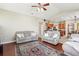 Spacious living room with hardwood floors, ceiling fan, and views into the kitchen area at 5119 Whispering Leaf Trail, Valrico, FL 33596