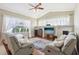 Comfortable living room with plush seating, hardwood floors, and large windows at 5119 Whispering Leaf Trail, Valrico, FL 33596