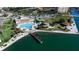 Aerial view capturing waterfront amenities including a pool, docks, recreation area and lush landscaping at 5200 Brittany S Dr # 204, St Petersburg, FL 33715