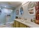 Updated bathroom featuring double sinks, updated vanity, and a glass enclosed shower at 5200 Brittany S Dr # 204, St Petersburg, FL 33715