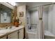 Cozy bathroom featuring a tub with shower, tiled walls, and a stylish sink vanity at 5200 Brittany S Dr # 204, St Petersburg, FL 33715