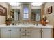 Bathroom featuring a double sink vanity with white cabinets and decorative accents at 5200 Brittany S Dr # 204, St Petersburg, FL 33715