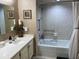 Bright bathroom featuring a tub with shower, tiled walls, and a stylish sink vanity at 5200 Brittany S Dr # 204, St Petersburg, FL 33715