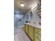 Bathroom featuring double sinks, updated vanity, and a glass enclosed shower at 5200 Brittany S Dr # 204, St Petersburg, FL 33715