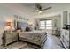 The modern bedroom showcases marble floors, a comfortable bed, and scenic water views at 5200 Brittany S Dr # 204, St Petersburg, FL 33715