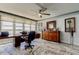 Well-lit bedroom featuring a workstation, dark wood accents and a ceiling fan at 5200 Brittany S Dr # 204, St Petersburg, FL 33715