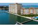 Exterior of a modern high-rise condominium complex with waterfront access and a pool at 5200 Brittany S Dr # 204, St Petersburg, FL 33715