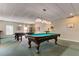 A game room featuring pool tables with classic overhead lighting and seating for entertainment at 5200 Brittany S Dr # 204, St Petersburg, FL 33715