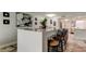 Kitchen island with bar seating and a view of a living room with luxurious furnishings at 5200 Brittany S Dr # 204, St Petersburg, FL 33715