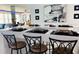 Stylish kitchen island with seating, perfect for entertaining, with a living area visible in the background at 5200 Brittany S Dr # 204, St Petersburg, FL 33715