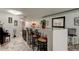 Kitchen island with seating, piano, and marble flooring, showcasing an open floor plan at 5200 Brittany S Dr # 204, St Petersburg, FL 33715
